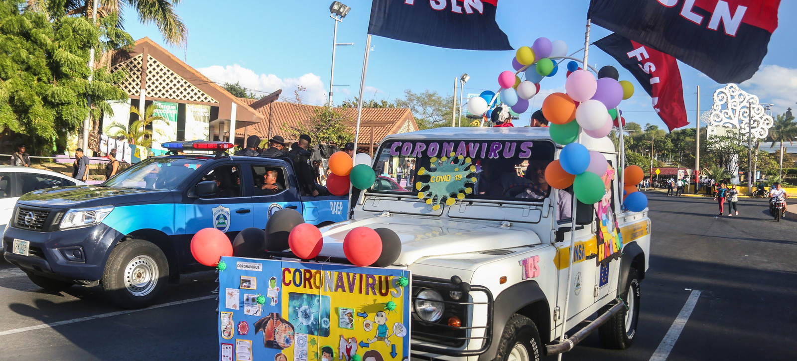A car with a sign reading 'Coronavirus' and sandinista's flags waving is parked in a demonstration called 'Love in times of COVID-19' in Managua, on March 14, 2020. (Photo by INTI OCON / AFP)